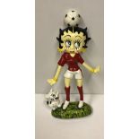 A modern painted cast iron figure of Betty Boo with football on head,