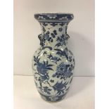 An early 19th Century Chinese blue and white vase with waisted neck and rounded rim,