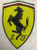 A modern painted cast iron sign bearing "Ferrari" emblem, approx 29.