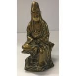 A Chinese bronze figure of Guan Yin seated with scroll in her hands,