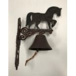 A painted cast metal "Heavy Horse" bell 29 x 41 cm