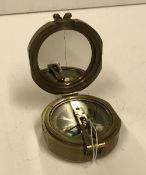 A modern reproduction heavy brass Brunton compass bearing label inscribed "Makers to The Queen