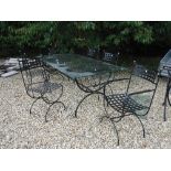 A wrought iron framed glass topped table,