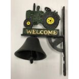 A painted cast metal sign inscribed "Welcome" and decorated with a tractor and bell 32 x 20 cm