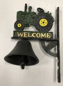 A painted cast metal sign inscribed "Welcome" and decorated with a tractor and bell 32 x 20 cm