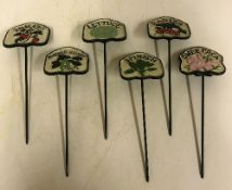 A set of six painted cast iron salad signs inscribed "Sweet Pea", "Tomato", "Runner Beans",