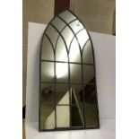 A Gothic style arched outdoor mirror,
