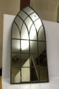 A Gothic style arched outdoor mirror,