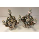 A pair of early 20th Century Continental porcelain figural candlesticks, 31.