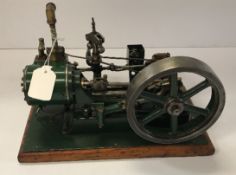 A vintage Stuart Turner No. 9 stationary steam engine, green painted on oak base, approx 18.