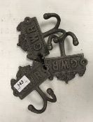 Three modern painted cast iron robe hooks inscribed "GWR"