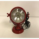 A red tractor headlight style table lamp,