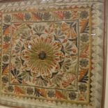 An Indian needlework panel with stylised flower head decoration to centre and applied mirrored