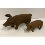 A small modern cast iron pig ornament, approx 30 cm long, together with a larger version,