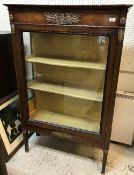 A 19th Century Continental mahogany display cabinet in the Empire taste with brass embellishments