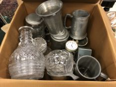 A collection of pewter tankards, glass decanters and an over-sized pocketwatch,