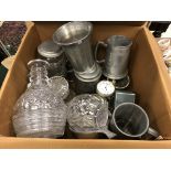 A collection of pewter tankards, glass decanters and an over-sized pocketwatch,