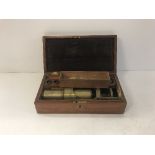 A Victorian lacquered brass simple monocular brass microscope with various accessories and ivory