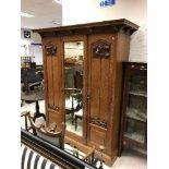 A late Victorian oak wardrobe in the Art Nouveau manner,