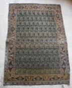 A Kashan rug with all over leaf decoration on a blue ground,