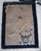 Three various Chinese rugs, one with vase of flowers decoration on a cream ground,