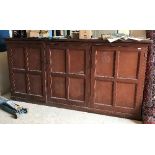 A late 19th Century Continental stained pine housekeeper's cupboard with three cupboard doors,