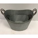 Two large oval galvanised planters 65 cm wide and a single smaller to match