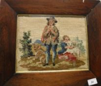 A Victorian needlework panel depicting a couple with two dogs, housed in a rosewood veneered frame,