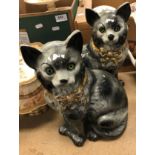 A pair of Staffordshire glazed pottery figures of seated cats with glass eyes,