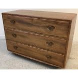 An Ercol elm chest of three drawers,