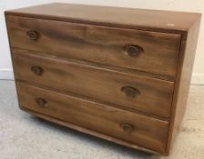 An Ercol elm chest of three drawers,