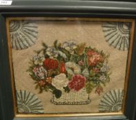 A needlework panel depicting a basket of flowers,