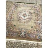 A Chinese superwash rug with central floral cream ground medallion on a gold ground,