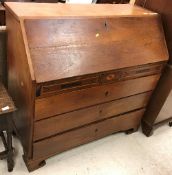 A George IV oak and inlaid bureau as a marriage piece the plain top over a sloping fall enclosing a