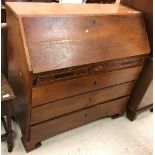 A George IV oak and inlaid bureau as a marriage piece the plain top over a sloping fall enclosing a