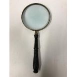 An ebonised handled 6" table magnifying glass