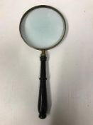 An ebonised handled 6" table magnifying glass