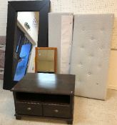 A dark stained oak framed rectangular wall mirror, a modern upholstered headboard and footboard,