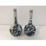 A near-matching pair of 19th Century Chinese blue and white gourd shaped vases,