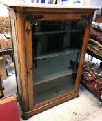 A Victorian satin walnut display cabinet with grey veined white marble top over a single glazed