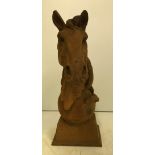 A modern cast metal Horse head on ball figure with rust effect patination,