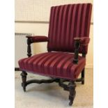 A Victorian upholstered open arm hall chair, the arms on faceted tapering octagonal supports,