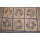 An early 20th Century patchwork quilt of panels of circular discs
