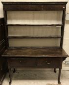 A 19th Century oak dresser, the plain top with moulded edge over two frieze drawers,