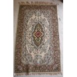 A large tapestry panel with central lozenge shaped medallion in puce, mustard, emerald,