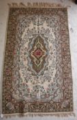 A large tapestry panel with central lozenge shaped medallion in puce, mustard, emerald,