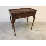 A reproduction burr walnut veneered silver table, the dished top over a fitted drawers,