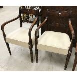A pair of late George III mahogany bar back carver chairs with moulded decoration and upholstered
