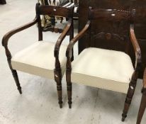 A pair of late George III mahogany bar back carver chairs with moulded decoration and upholstered