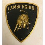 A modern painted cast iron sign inscribed "Lamborghini",